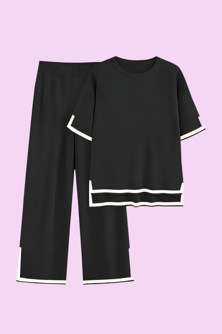 Black outfit with white trim on a white background